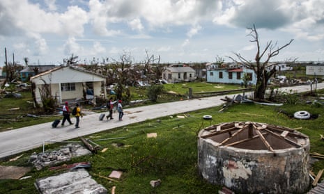 Residents of Codrington and Red Cross workers survey damage on the island of Barbuda in the aftermath of Hurricane Irma
