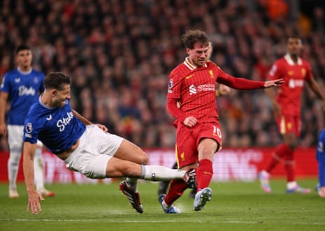 Alexis Mac Allister of Liverpool is fouled by Everton's James Tarkowski at Anfield