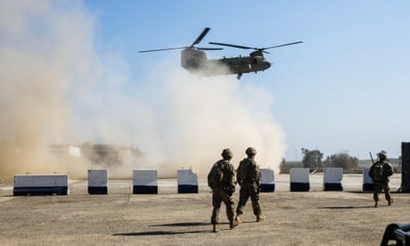 FILES-IRAQ-CONFLICT<br>(FILES) In this file photo taken on February 22, 2017 US troops walk as a US Army C-47 Chinook helicopter flies over the village of Oreij, south of Mosul. - US President Donald Trump will announce further troop withdrawals from Iraq and Afghanistan in the next few days, a senior administration official said on September 8, 2020. (Photo by AHMAD AL-RUBAYE / AFP) (Photo by AHMAD AL-RUBAYE/AFP via Getty Images)