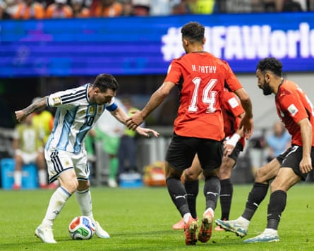 Messi, with the ball at his feet, takes on three Egypt players