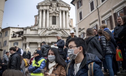 Tourists in face masks near the Trevi Fountain in Rome