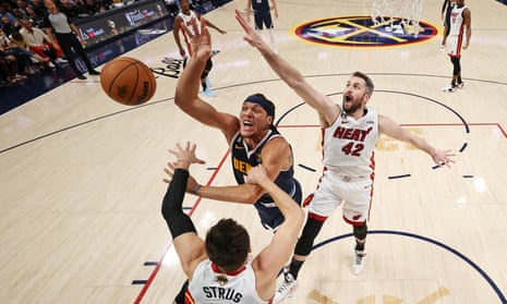Denver Nuggets forward Aaron Gordon (50) loses control of the ball against Miami Heat guard Max Strus (bottom) and forward Kevin Love (right) in the early stages of Game 2 of the NBA finals
