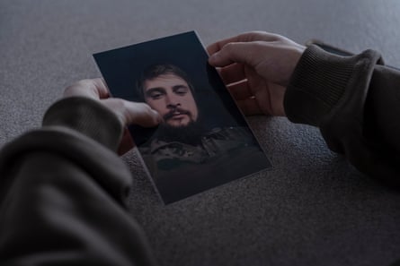 Yaryna Herashchenko holds a photo of her partner, Rostyslav, who died fighting in December 2023.