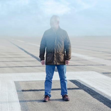 Alan Irwin on a runway with his face obscured by smoke