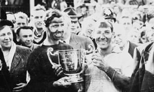 Stirling Moss, right, and his team-mate Tony Brooks, after winning the British Grand Prix at Aintree, 1957.