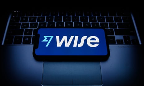 A Wise logo displayed on a phone screen and laptop keyboard are seen in this illustration photo.