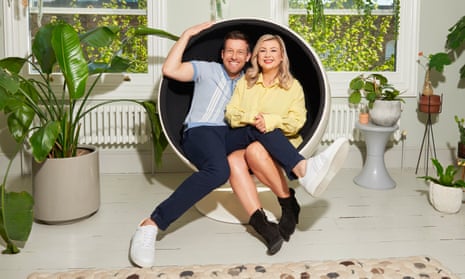 Chris and Rosie Ramsey sit entwined in a capsule chair, surrounded by plants in a white room