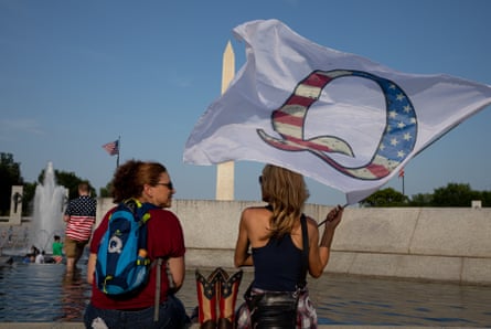 women with Q flag and Q backpack