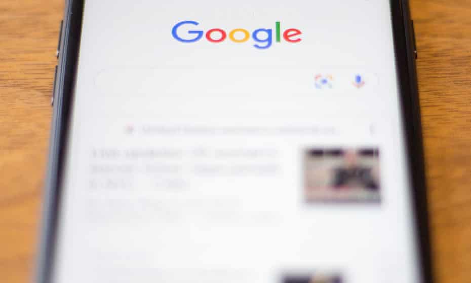 A mobile phone shows the Google search home page.
