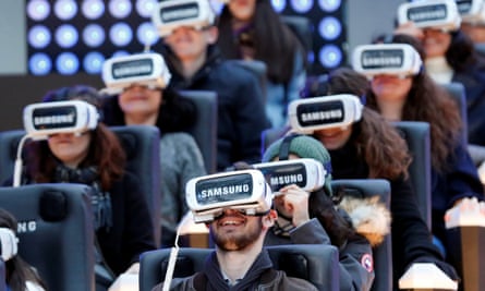 People test virtual reality Samsung Gear VR glasses at the Grand Palais exhibition hall