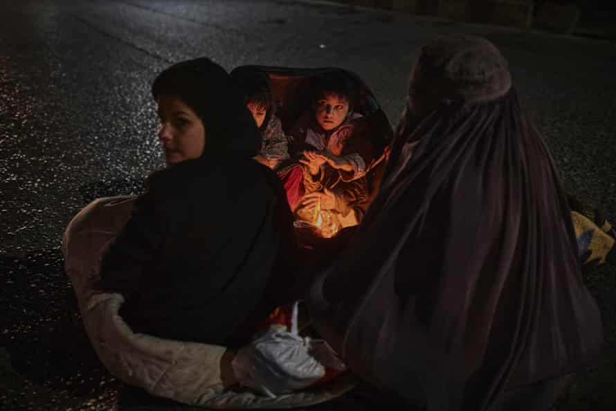 A woman and her four children beg in the street in Kandahar.
