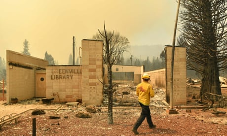 A firefighter surveys the Greenville library in a decimated downtown Greenville, California.