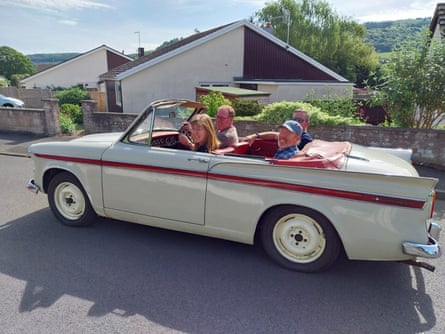 Paul and his siblings smile forthe camera as they sit in the family’s Sunbeam Rapier