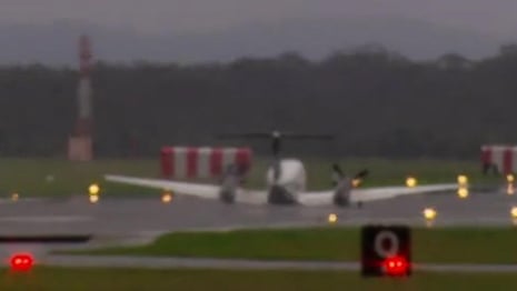 Small plane makes emergency landing at Newcastle airport after landing gear fails – video 