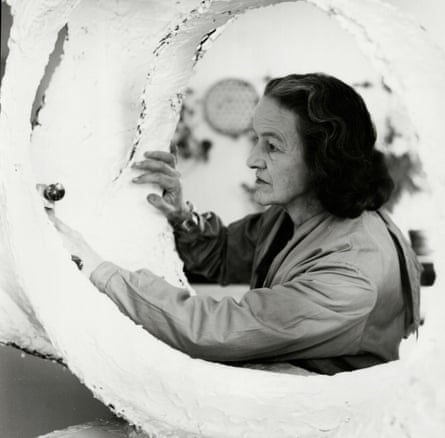 Hepworth shaping the plaster, seen through the hole in the work itself
