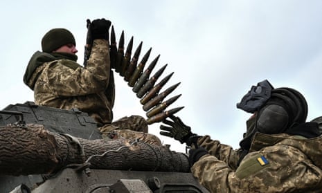 Ukrainian soldiers load ammunition during a drill