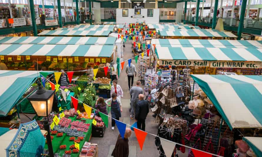 The interior of Shrewsbury Market Hall with fresh produce and fashion for sale