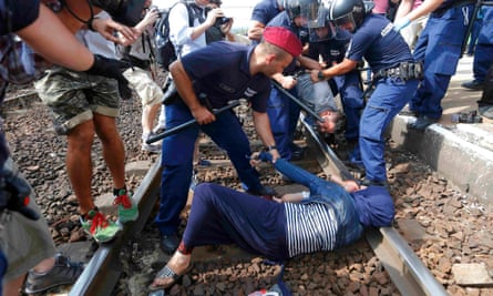 Hungarian police detain refugees on the tracks at Bicske station.