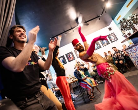 Jalil Debit claps as the activist and artist The Darvish C performs at Kanaan in July 2024.