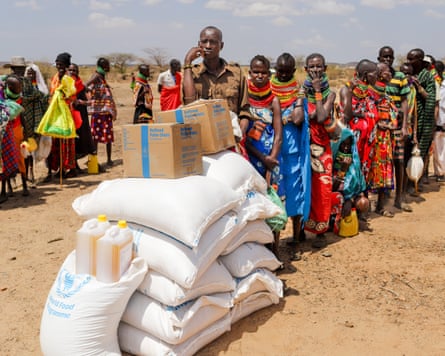 Locals queue to receive food aid