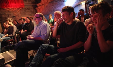 An audience enjoys a live comedy show at the Edinburgh festival. 