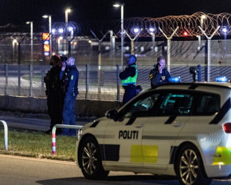 Police officers stand guard after all traffic has been closed at the Copenhagen Airport due to drone reports in Copenhagen, Denmark.