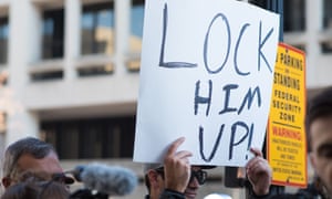 A protester holds up a sign after Michael Flynn arrived at the US federal court in Washington DC on Friday.