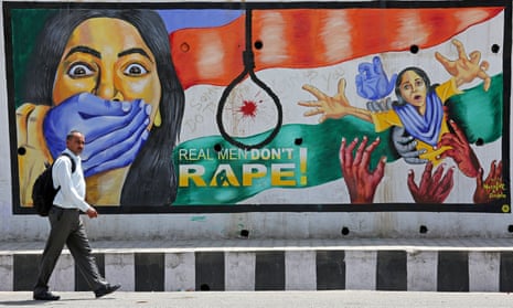 A man walks past a graffiti depicting a message in protest against rape, in Jammu, on 22 April