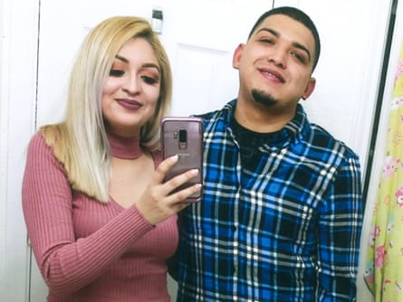 a husband and wife smile for a photograph