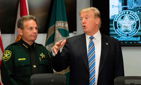 (FILES) In this file photo taken on February 16, 2018 US President Donald Trump (R) speaks with Broward County Sheriff Scott Israel (L) while visiting first responders at Broward County Sheriff’s Office in Pompano Beach, Florida, three days after a mass shooting that claimed 17 lives at a nearby high school. President Donald Trump signalled support on February 19, 2018 for a bipartisan effort to improve a national system of background checks for gun purchases in the wake of the Florida school shooting. “While discussions are ongoing and revisions are being considered, the president is supportive of efforts to improve the Federal background check system,” White House press secretary Sarah Sanders said in a statement. / AFP PHOTO / JIM WATSONJIM WATSON/AFP/Getty Images