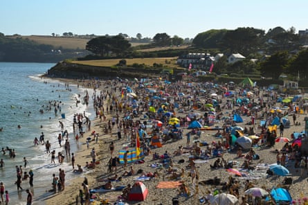 A busy Gyllyngvase beach on a sunny summer day in Falmouth, England.