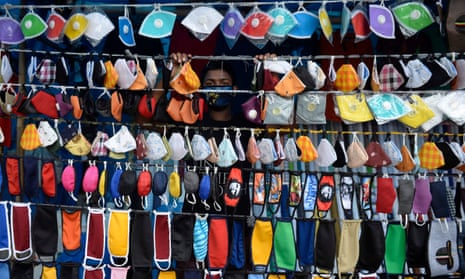 A vendor arranges facemasks to sell on a roadside in Hyderabad, India.