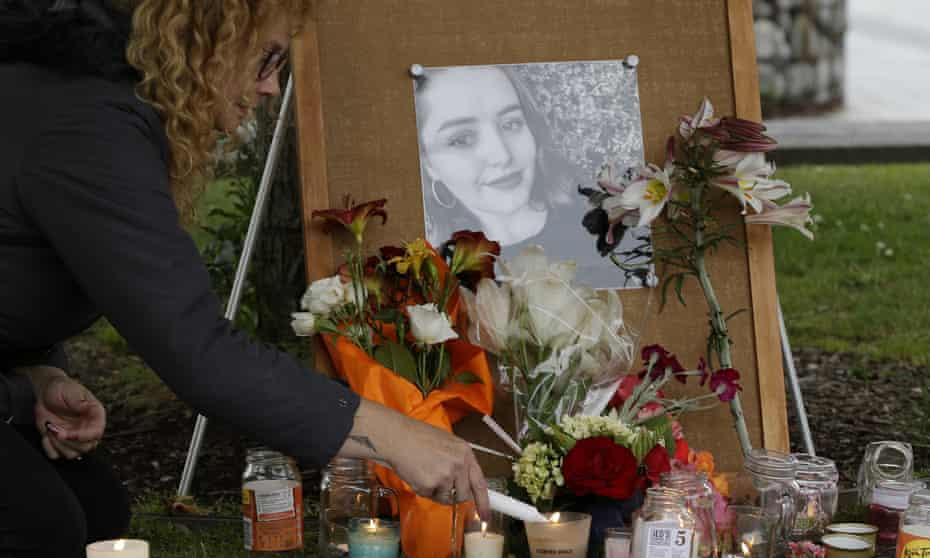A woman lights candles during a vigil for Grace Millane in Christchurch, New Zealand.