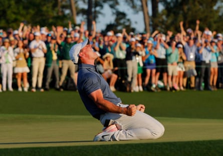 Rory McIlroy, on his knees on the 18th green, celebrates winning the Masters in a playoff
