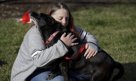 Debra Mejeur hugs her dog, Lola, Saturday in Wheaton, Illinois.