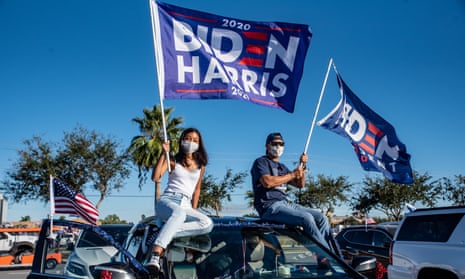 Attendees wave flags during a campaign event with Democratic vice-presidential nominee Kamala Harris in Edinburg, Texas, on 30 October 2020. 