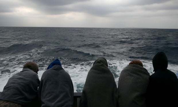 Migrants are seen aboard a rescue vessel in Mediterranean