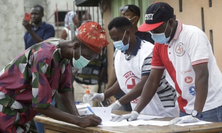 A Lagos resident registers with the Red Cross before receiving food aid.