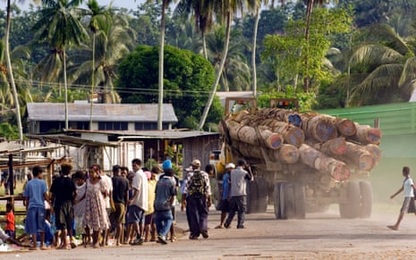 A logging truck heads through the village of Vanimo, Papua New Guinea, en route to the Vanimo Forest Products log camp where the logs will be loaded onto a ship for export to China.