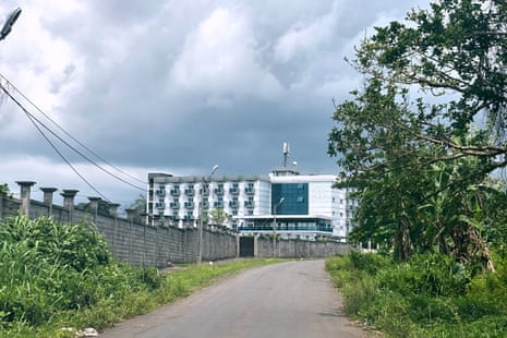The Bamy Hotel, where migrants are held, stands behind a wall in Malabo, Equatorial Guinea