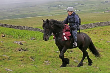 An elderly woman on horseback