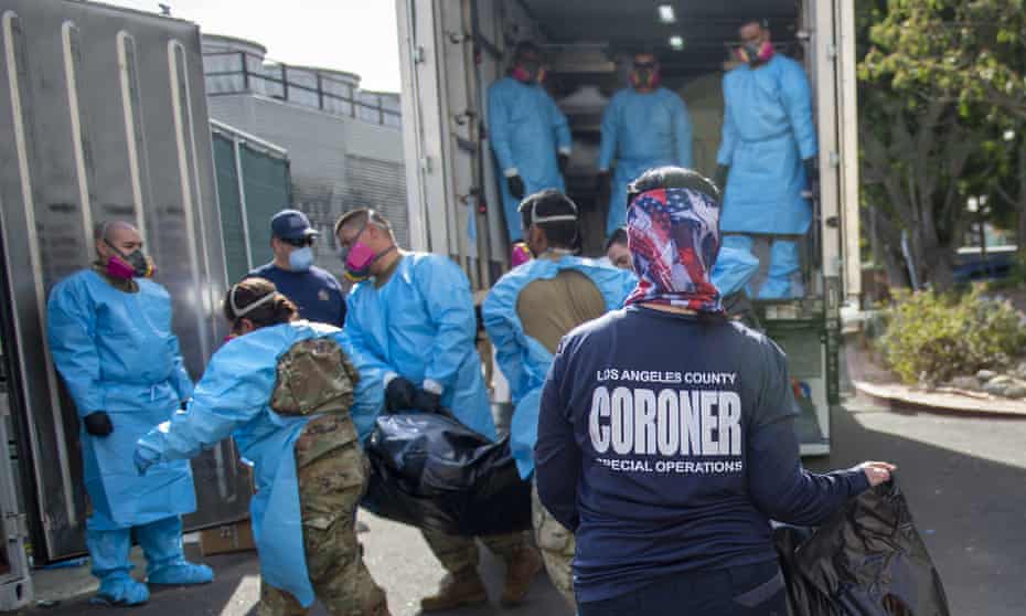 Officials and national guard members place bodies into temporary storage at the LA county medical examiner-coroner office last week.