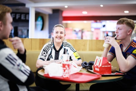 Shannon Higgott smiles for the camera. She and her nephews are wearing Newcastle football shirts