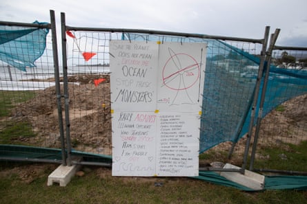 Makeshift signs opposing offshore windfarms are seen above Thirroul beach in the Illawarra region of NSW.