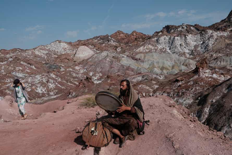 Odin plays daf (a traditional Persian drum) near Rainbow valley - a popular sightseeing spot. Hormoz island. Iran