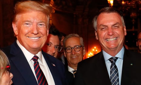 Jair Bolsonaro’s communications director Fabio Wajngarten (second left, partially obscured), is seen during a meeting with Donald Trump at Mar-a-Lago in Florida.