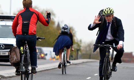 Boris Johnson waves away a fellow cyclist’s hand gesture as he opens the first cycle superhighway in London.