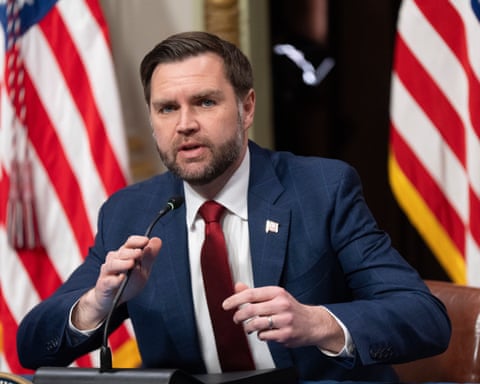 JD Vance speaking at a microphone