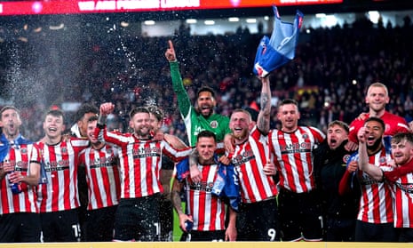 Sheffield United players celebrate being promoted to the Premier League after winning their Championship match over against West Bromwich Albion at Bramall Lane.