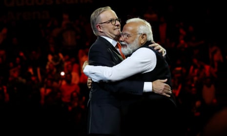 Anthony Albanese and Narendra Modi embrace on stage at Qudos Bank Arena